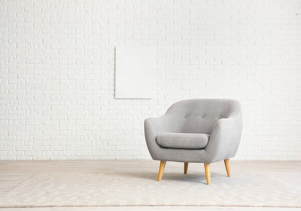 Minimalist interior with grey armchair
