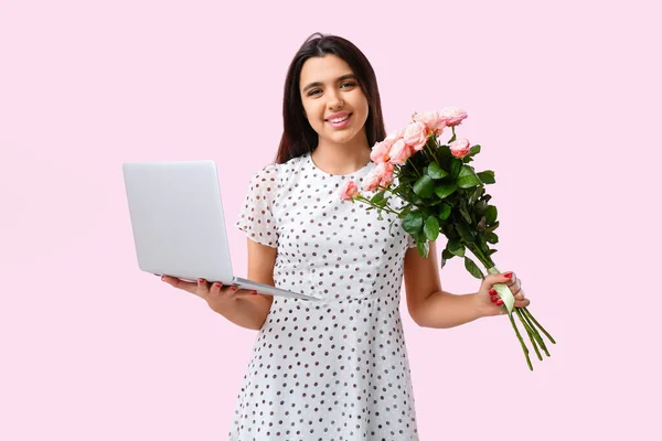 Young woman with roses and laptop on pink background. Online dating concept