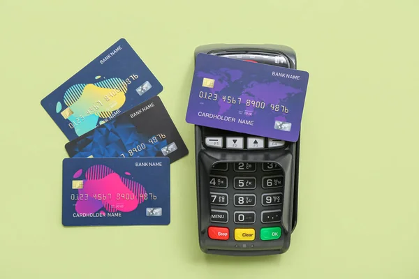 Payment terminal with credit cards on green background