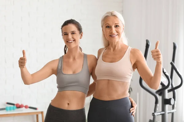 Body positive women hugging in gym