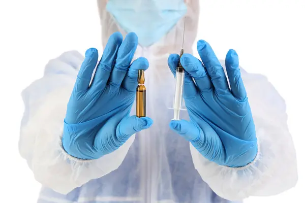 Medical worker in protective suit, with ampule and syringe on white background, closeup. Vaccination concept