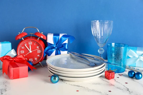 Decorated Christmas table setting on blue background
