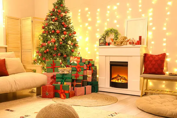 Interior of living room with fireplace, Christmas tree and glowing lights in evening