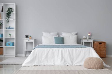 Büyük yataklı ve masalı aydınlık yatak odasının içi.