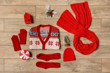 Ahşap arka planda süslemeleri olan şirin Noel çocuk kıyafetleri.
