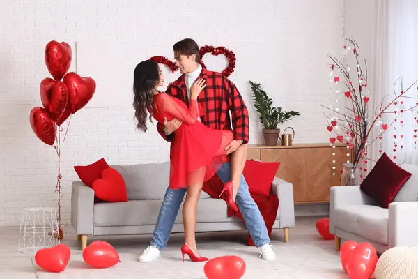 Young couple dancing at home on Valentine\'s Day