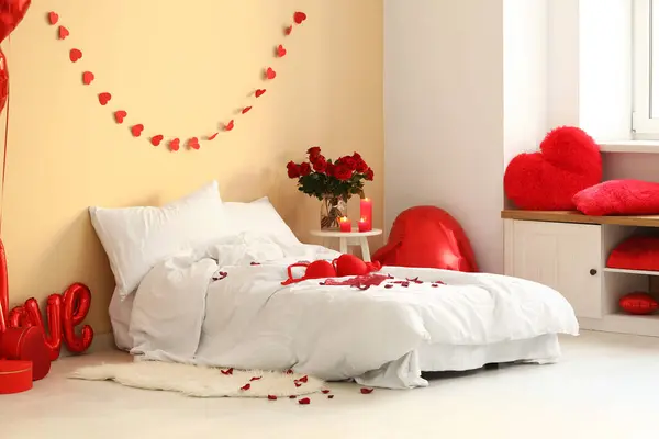 Interior of festive bedroom with different decorations and sexy underwear for Valentine's Day celebration