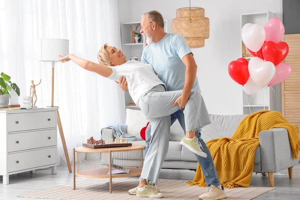 Mature couple dancing at home on Valentine\'s Day