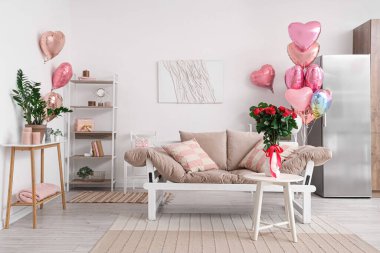 Sevgililer Günü için kalp şeklinde balonlarla dekore edilmiş şenlikli oturma odasının içi.