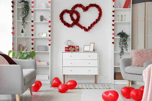 Interior of festive living room decorated with hearts for Valentine\'s Day celebration