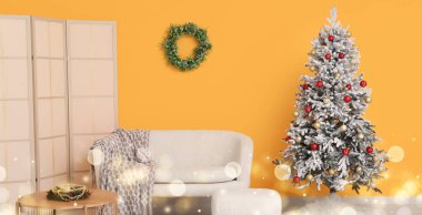 İçinde güzel bir Noel ağacı ve kanepe olan oturma odası.