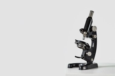 Işık duvarının yanındaki masada antika mikroskop