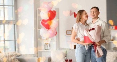 Young couple with gifts at home on Valentine's Day