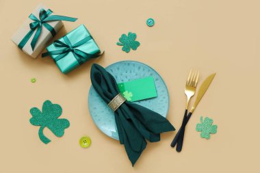 Beautiful table setting for St. Patrick's Day celebration on beige background