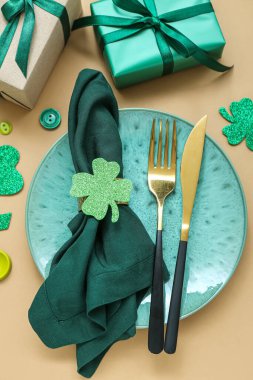 Beautiful table setting for St. Patrick's Day celebration on beige background