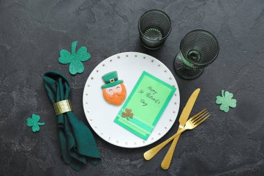Beautiful table setting for St. Patrick's Day celebration on black background