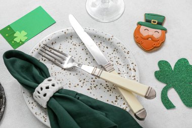 Beautiful table setting for St. Patrick's Day celebration on light background