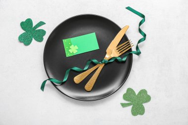 Beautiful table setting for St. Patrick's Day celebration on light background