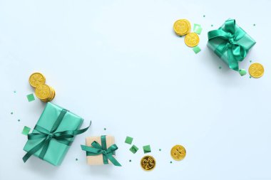 Gifts with golden coins and sequins on white background. St. Patrick's Day celebration