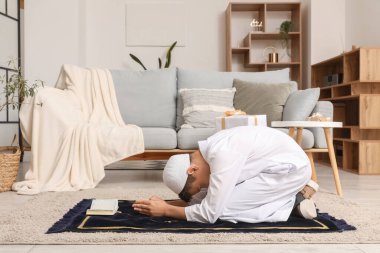 Little Muslim boy praying at home