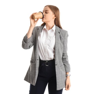 Pretty young businesswoman drinking coffee on white background