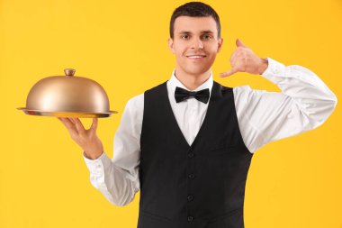 Male waiter with cloche showing 