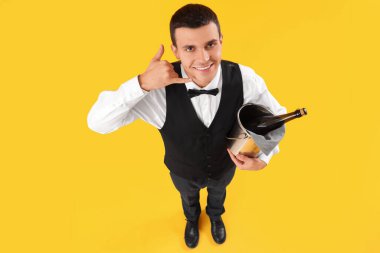 Male waiter with champagne showing 