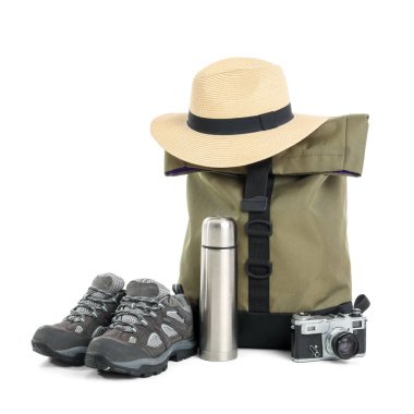 Set of camping equipment with backpack, hat and thermos on white background clipart