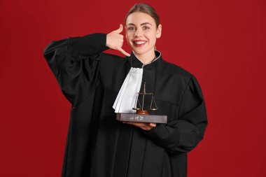 Young judge with law book and justice scales showing 