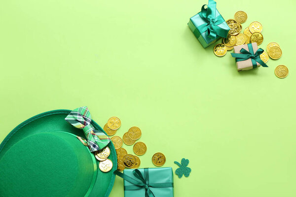Leprechaun hat with bow tie, gifts and golden coins on light green background. St. Patrick's Day celebration