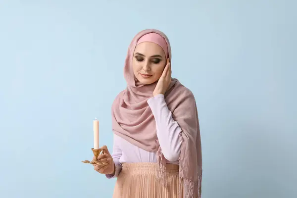 Young Muslim Woman Burning Candle Blue Background Islamic New Year — 스톡 사진