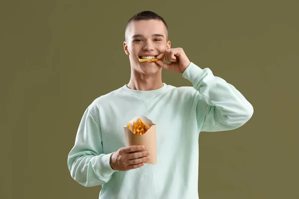 Young Man Eating French Fries Color Background — Stock Photo, Image