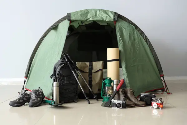 Camping tent with different hiking equipment indoors