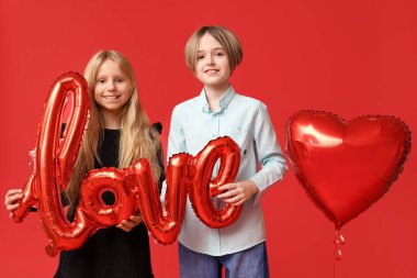 Little children with word LOVE and balloon on red background. Valentine's Day celebration