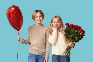 Little children with heart-shaped balloon and roses on blue background. Valentine's Day celebration