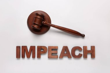 Judge gavel and word IMPEACH on white background