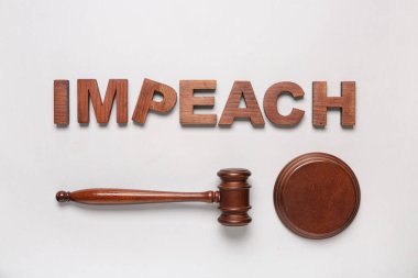 Judge gavel and word IMPEACH on white background