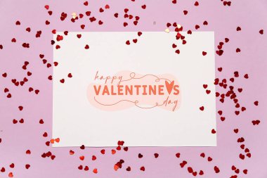 Card with text HAPPY VALENTINE'S DAY and red hearts on lilac background