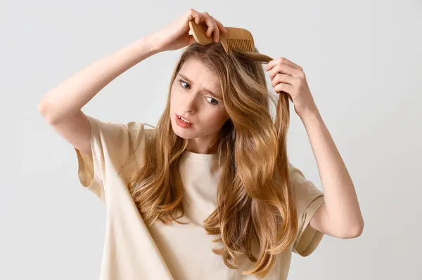 Upset Young Woman Hair Loss Problem Combing Light Background — 스톡 사진