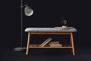 Kitaplı gri bank ve siyah arka planda standart lamba.