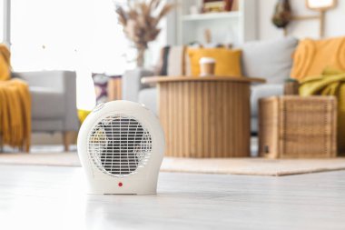 Electric fan heater on floor in living room