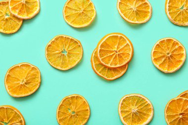 Dried orange slices on turquoise background