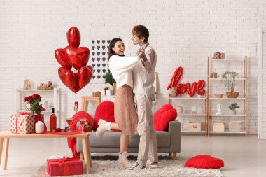 Young couple dancing at home. Valentine's day celebration