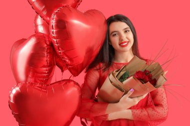 Beautiful young woman with bouquet of roses and heart-shaped air balloons for Valentine's day on red background