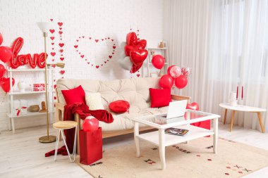 Interior of living room with comfortable sofa and decor for Valentine's day