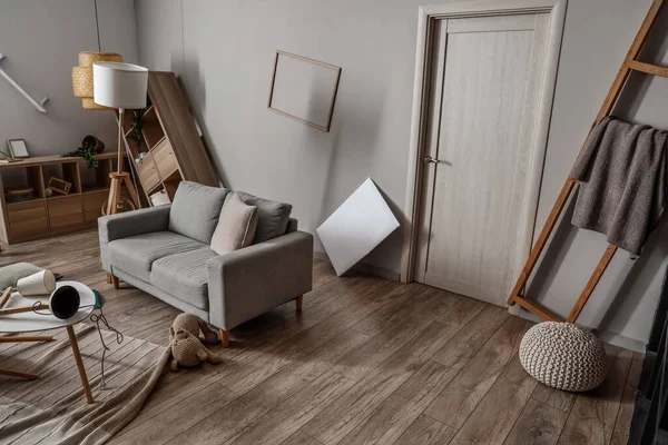 Shelving units with sofa in messy living room