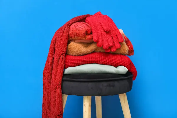 Stack Folded Sweaters Scarf Gloves Chair Blue Background — Stockfoto