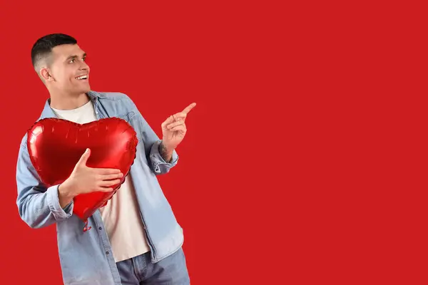 Handsome Young Man Heart Shaped Air Balloon Pointing Something Red — Stock Photo, Image