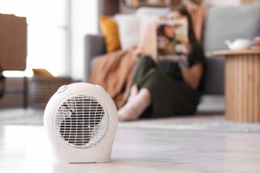 Electric fan heater on floor in living room