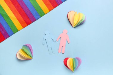 Renkli arka planda kağıt insan figürleri, kalpler ve gökkuşağı bayrağı olan kompozisyon. Sevgililer Günü kutlaması